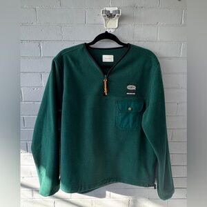 Aimee Leon Dore green fleece quarter zip sweater.